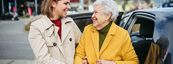 caregiver helping older woman